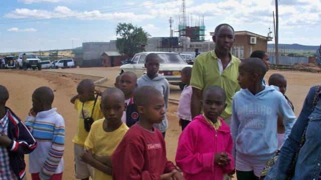 Kids with the bus driver at the Tanzanian-Kenyan border